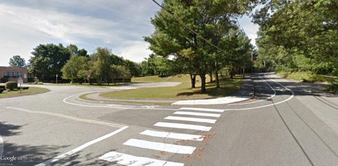 This figure is an image showing the recently striped parking lane and bicycle lane at their end closest to the entrance of West Memorial School.